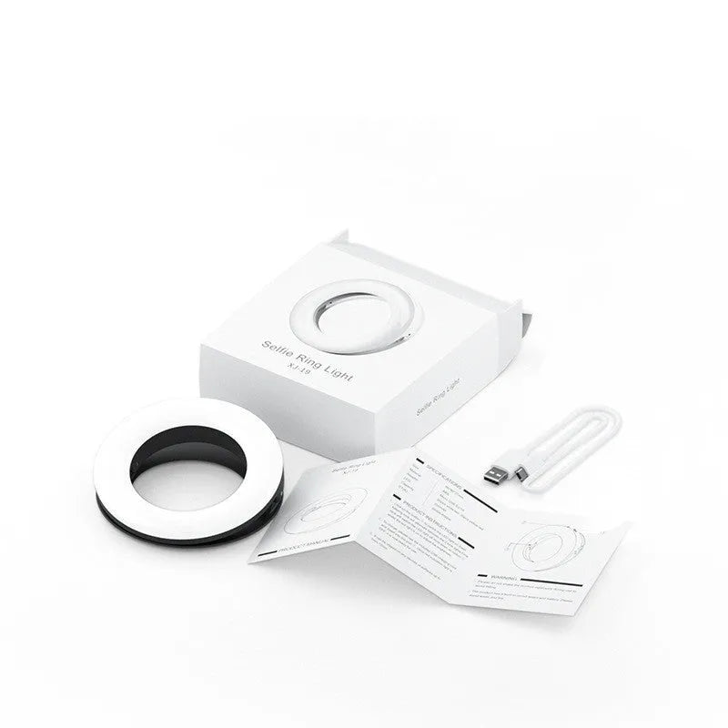 Black portable LED ring light for mobile phone photography with USB cable.