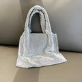 Silver evening handbag with shiny rhinestone decoration and cotton thread construction
