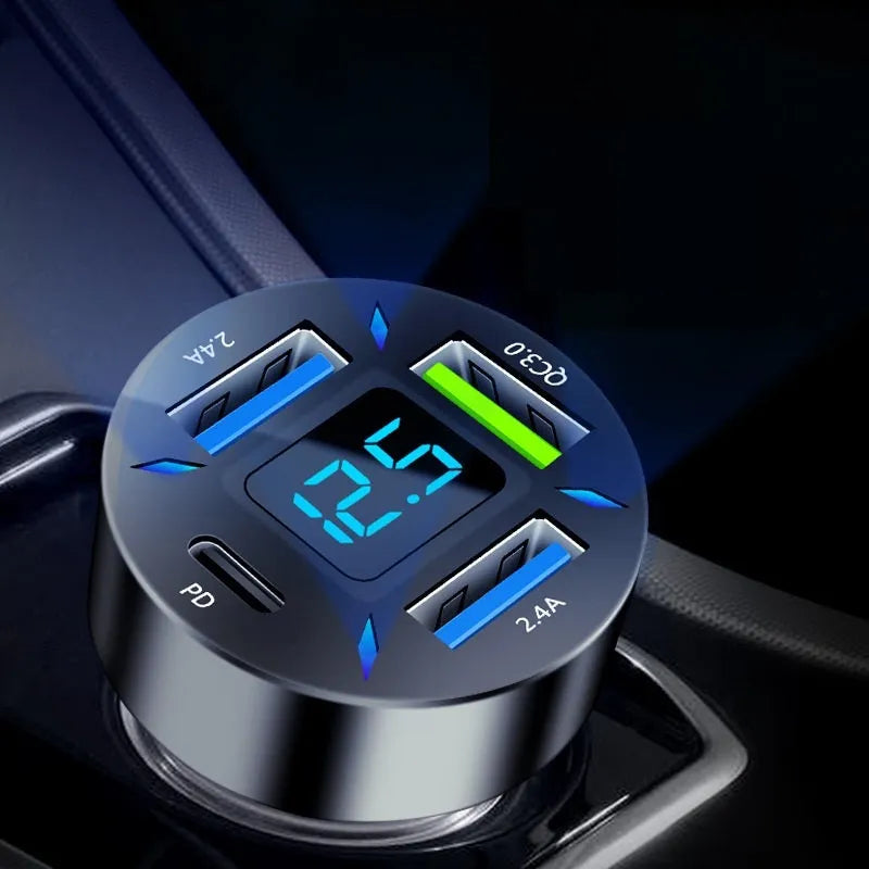 Black four-port car USB charger with LED digital display plugged into a vehicle socket.