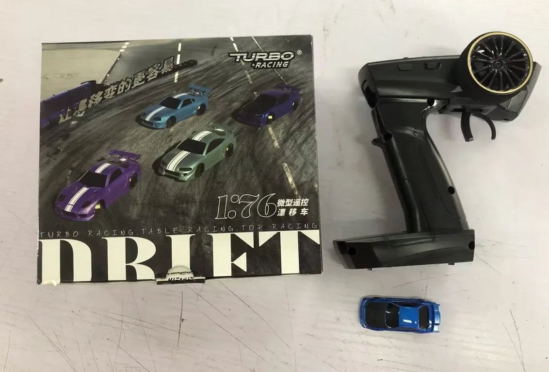 Turbo Racing C64 1:76 scale RC drift car with blue body and P21-SVC remote control transmitter