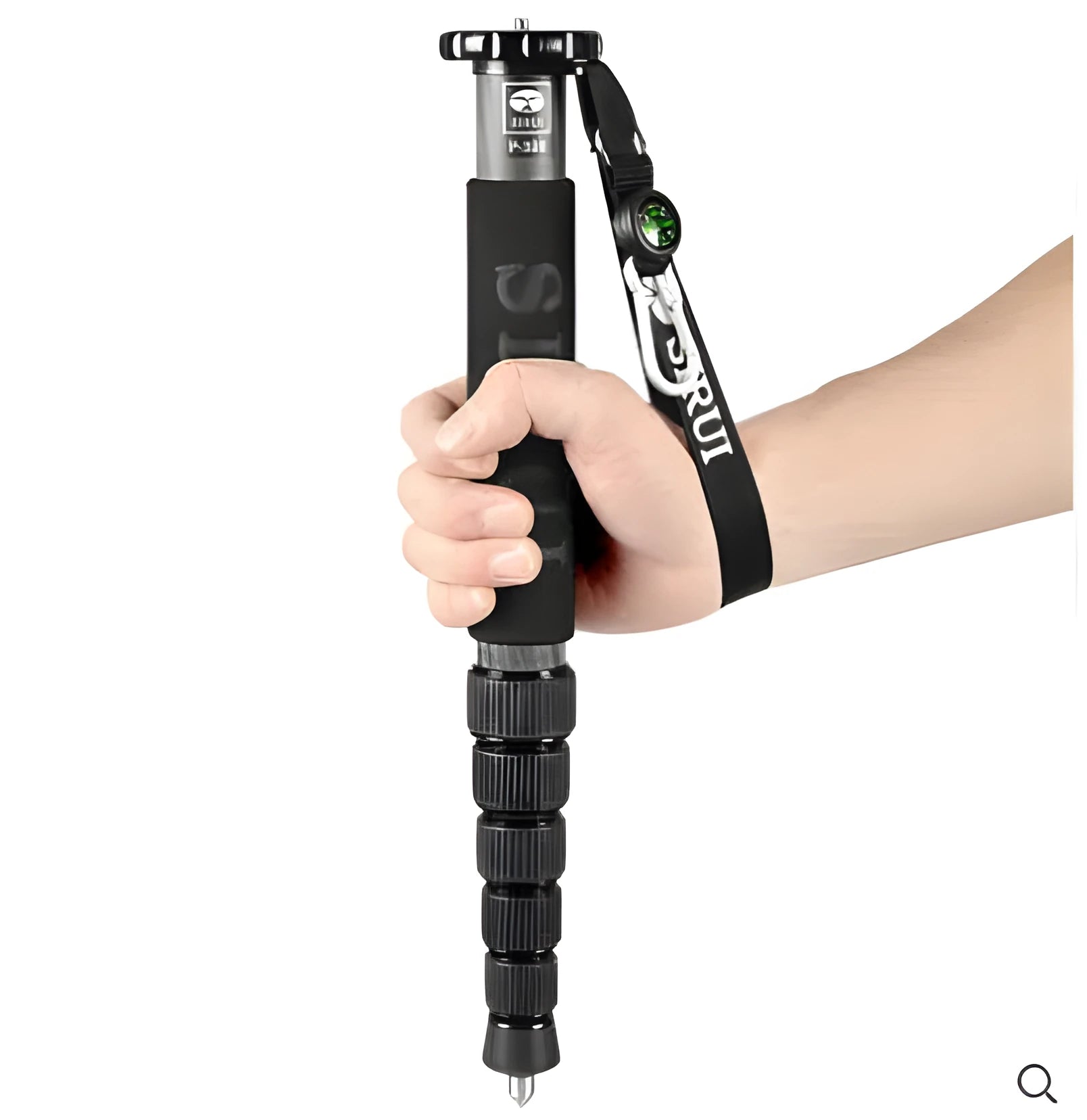 Black carbon fibre telescopic camera monopod fully extended next to an SLR camera