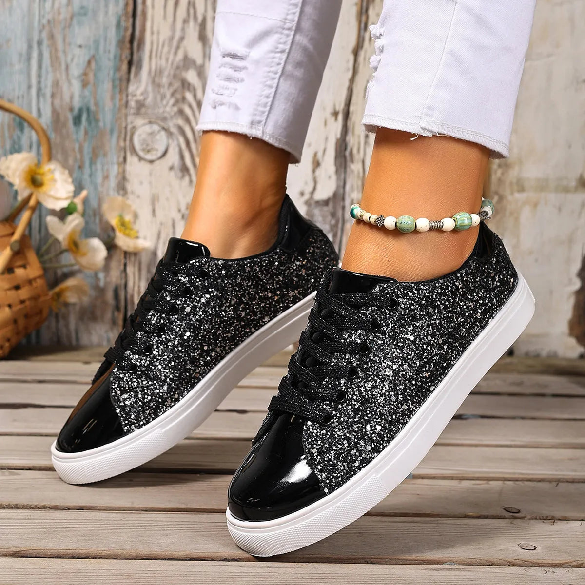 Women's plus size black sequined lace-up board shoes with flat rubber sole.