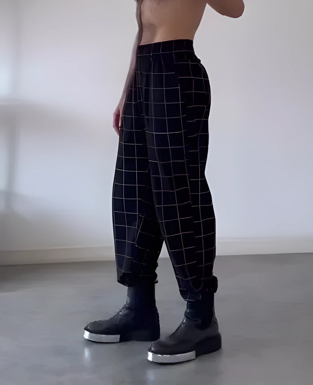 Men's plaid apron trousers showing the front bib design and adjustable straps.