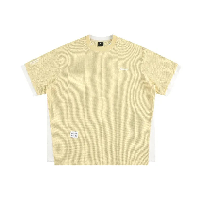 Retro alphabet embroidered loose fit short-sleeved waffle t-shirt on a hanger.