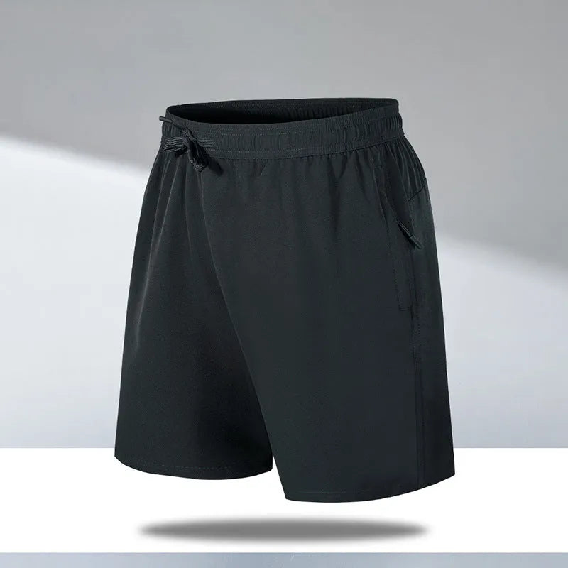Man wearing loose-fit black quick-dry sports shorts made from polyester ice silk fabric.