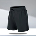 Man wearing loose-fit black quick-dry sports shorts made from polyester ice silk fabric.
