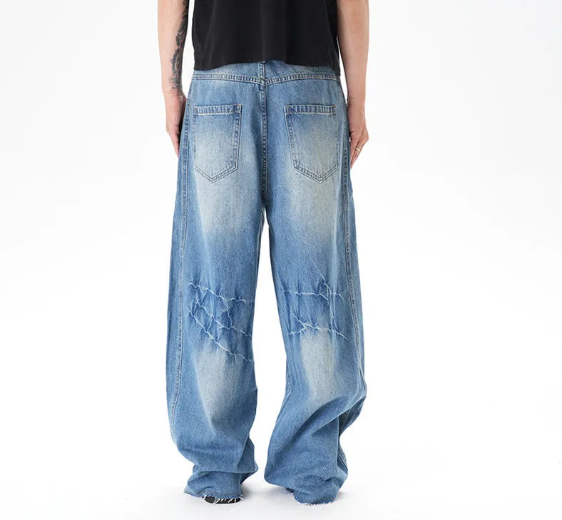 Cut washed vintage washed wide leg machete jeans in light blue denim fabric with zip fly