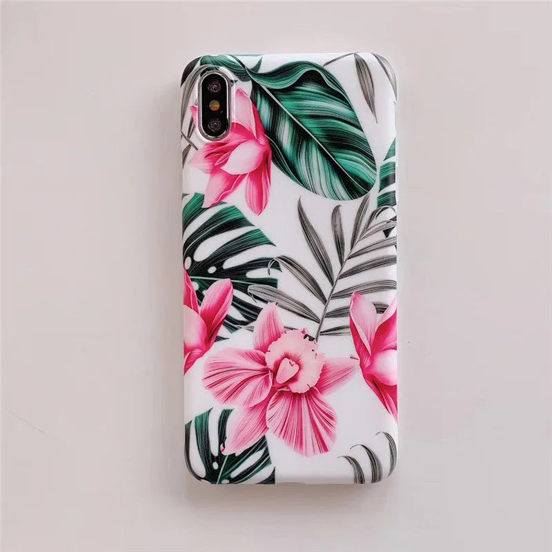 Pink floral pattern TPU back cover case for iPhone models on a table.