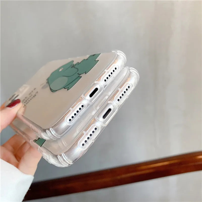 Clear transparent iPhone case with green dinosaur design on back, showing airbag-style edges.