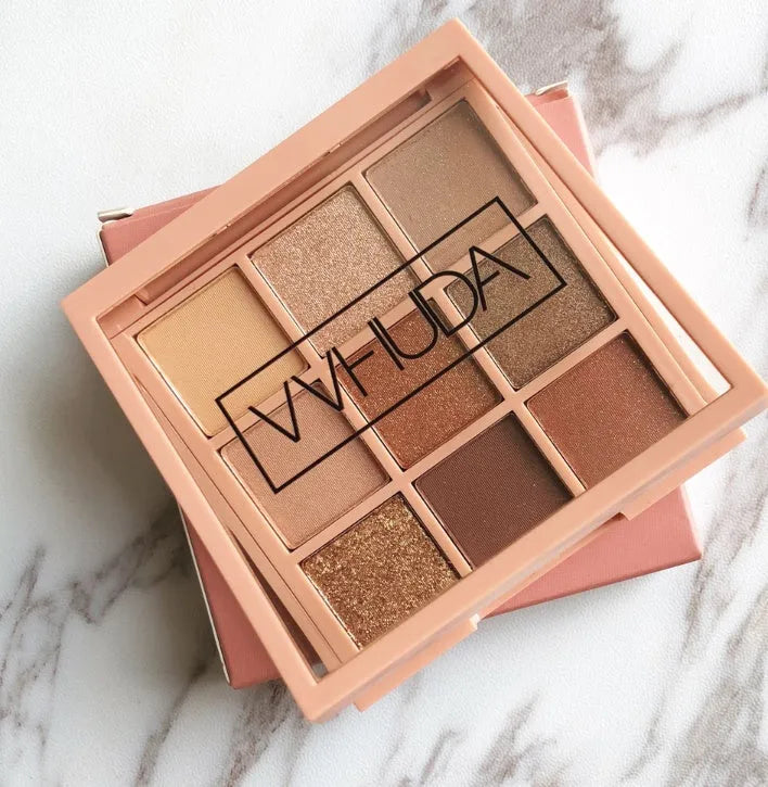 Nine-colour eyeshadow palette with warm brown, charred orange, and nude matte and pearlescent shades