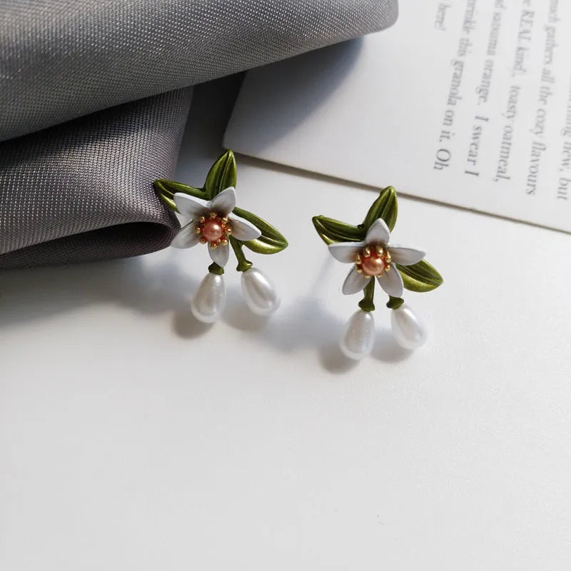 Alloy flower ear stud and clip set with sterling silver needle camellia design and contrasting colour floral motif