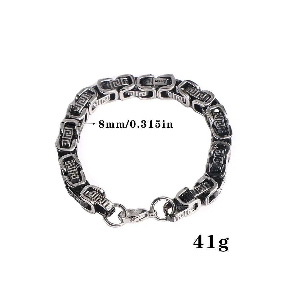 Retro black polished stainless steel geometric chain bracelet on a neutral surface