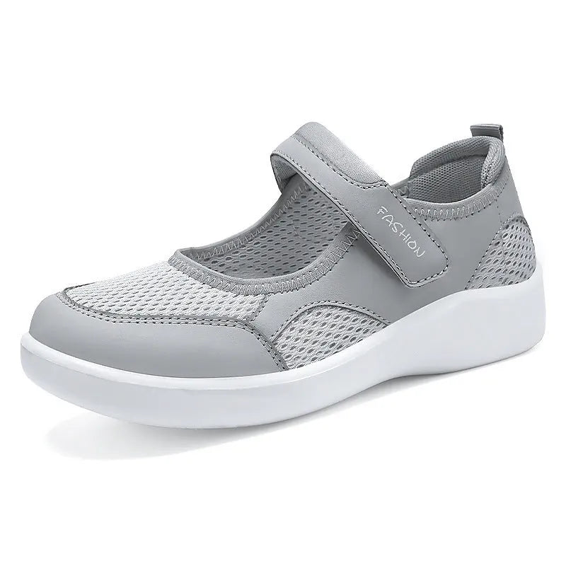 Women's low-top casual shoes in grey with mesh upper and Velcro strap.
