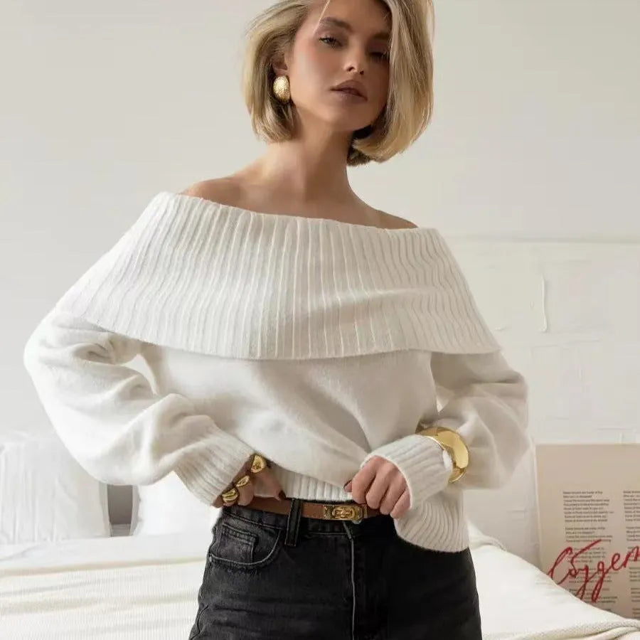 Woman wearing a grey off-the-shoulder sweater with a raised 3D texture pattern.