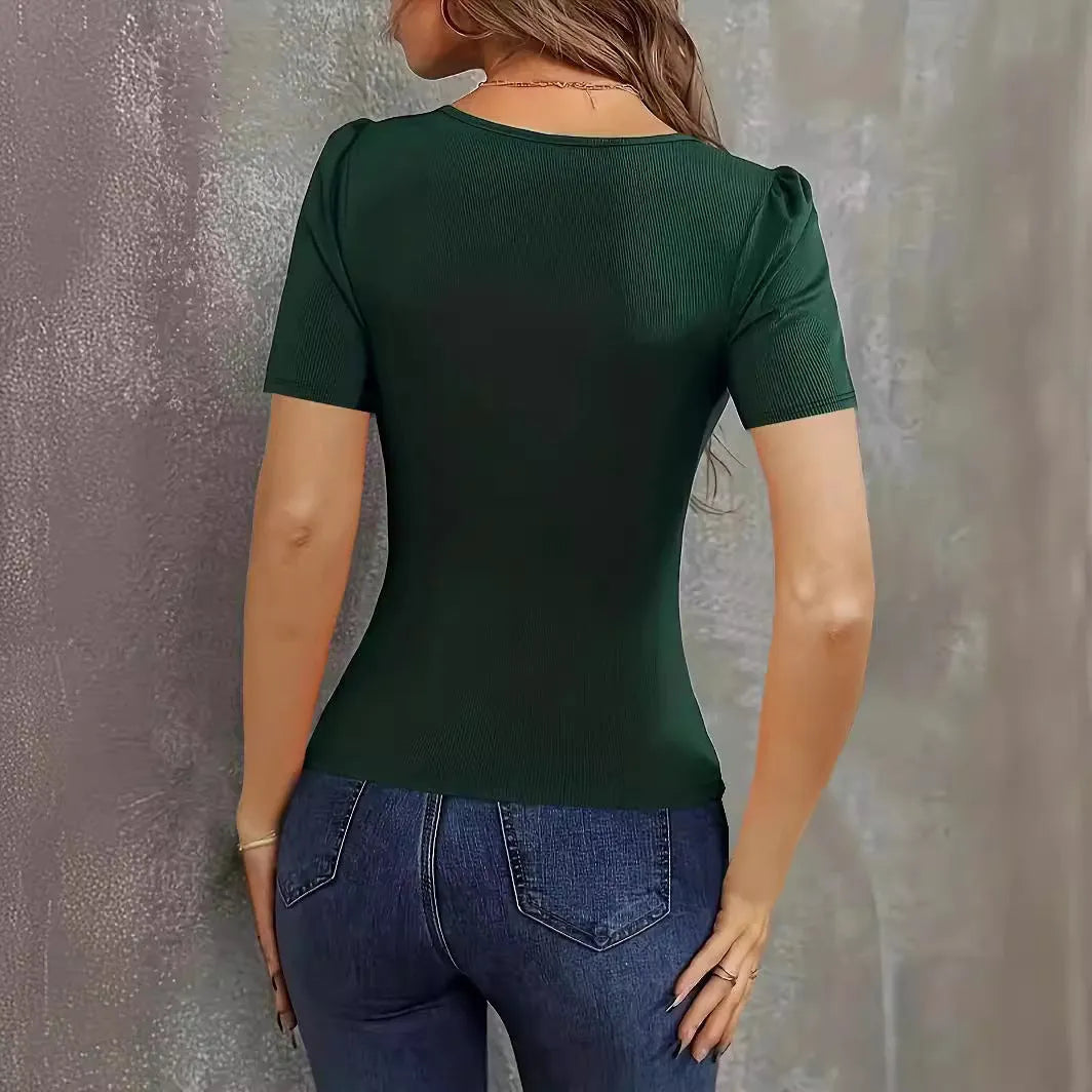 Woman wearing a wine red knitted short sleeve pullover with a low neckline and slim fit.