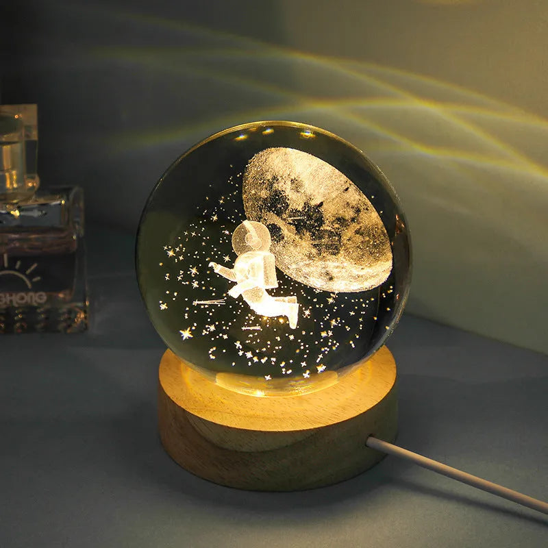 Transparent crystal ball night lamp with 3D carved jellyfish design, on a round base with USB cable.