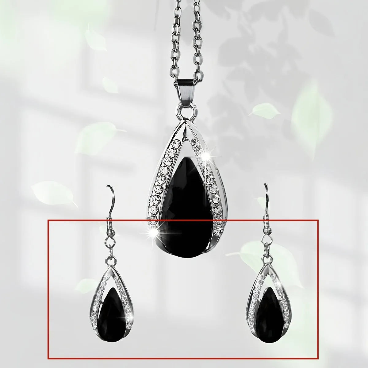 Black and red teardrop-shaped glass pendant necklace and matching earrings set made from alloy.