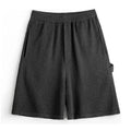 Cement grey men's straight-leg sports shorts with elastic waistband showing fifth-pants length measurement