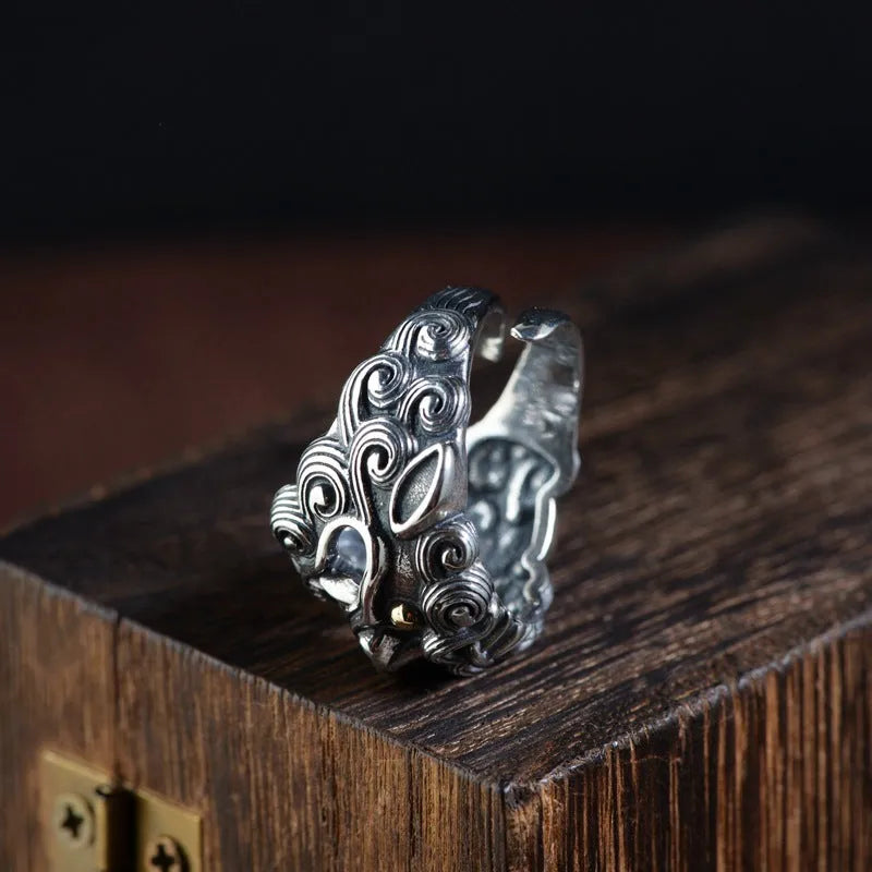 Silver open ring with a detailed Jibeast animal zodiac pattern and diamond design on a white background.