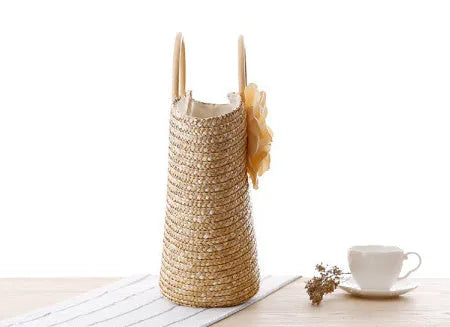 Natural primary colour woven straw bag beach bag handbag with shoulder straps on white background