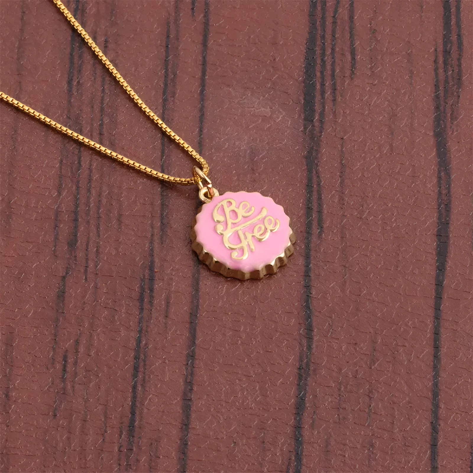 Gold plated copper bottle cap pendant necklace on a 40cm box chain.