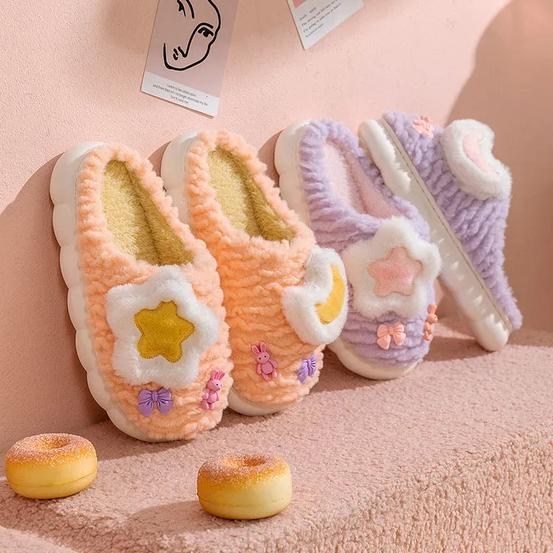 Women's light blue cartoon fleece-lined plush slippers with floral pattern and round toe.