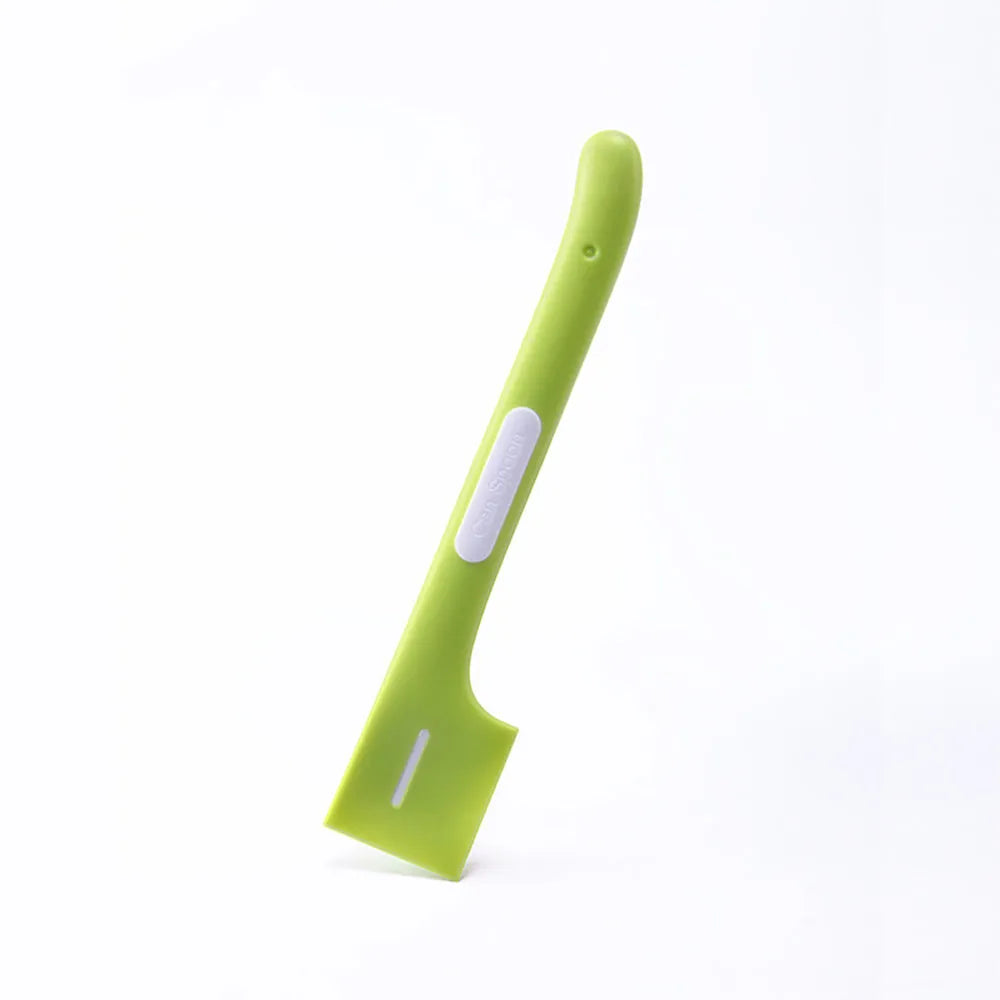 Long handled green pet food spoon for scraping canned wet food for cats and dogs.