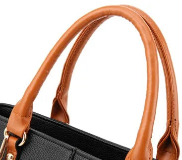 Women's PU leather crossbody shoulder bag in Black with silver-tone clasp, worn over shoulder