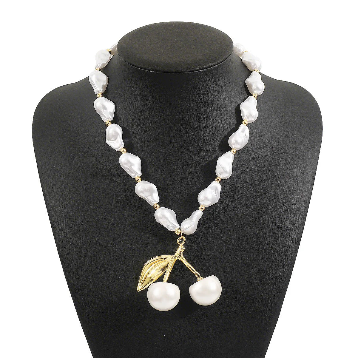 Gold tone irregular cherry and pearl necklace on a model, showing adjustable length up to 60cm.