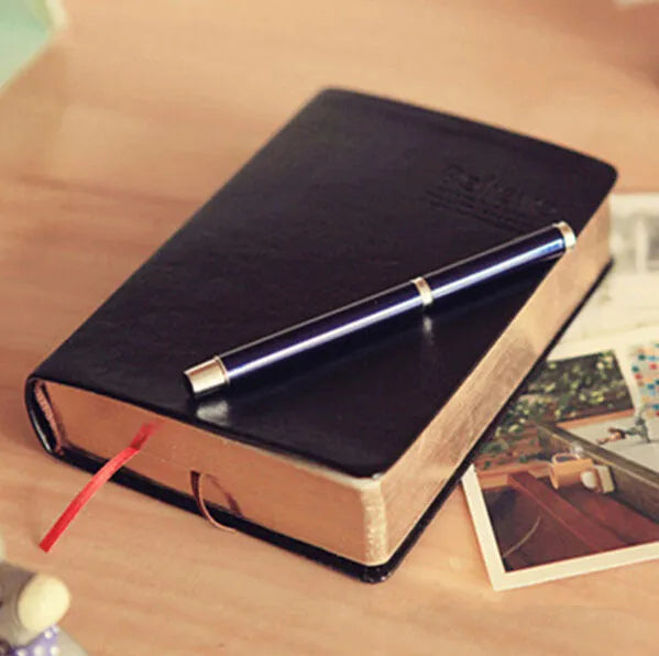 Large thick leather Phnom Penh notebook in gold, A6 size, 480 pages, open on a desk