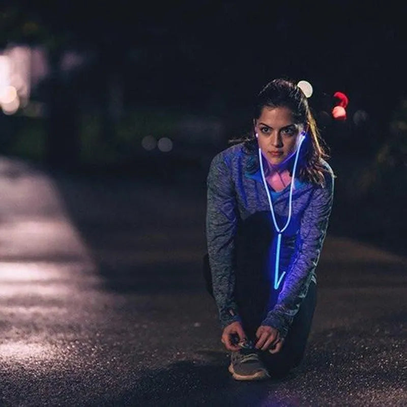 Blue Magic Light LED earphones with glowing cable connected to a phone showing rhythm-sync light effects.