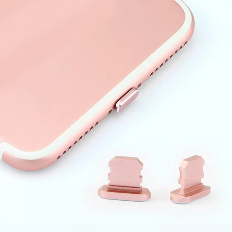 Aluminium alloy iPhone charging port dust plug in various colours on a dark background
