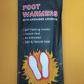 Self-heating foot warmer insoles in two sizes, walkable and battery-free, placed inside a pair of boots