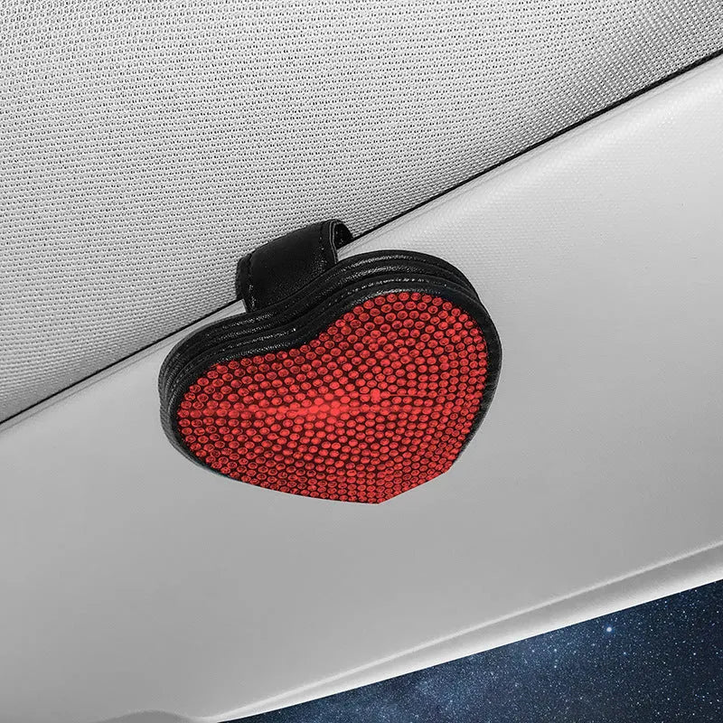 A black PU leather magnetic storage clip with a diamond pattern on a car sun visor, holding a pair of sunglasses.