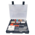 DIY floor and furniture repair kit with red handle and coloured wax sticks on a tile surface.
