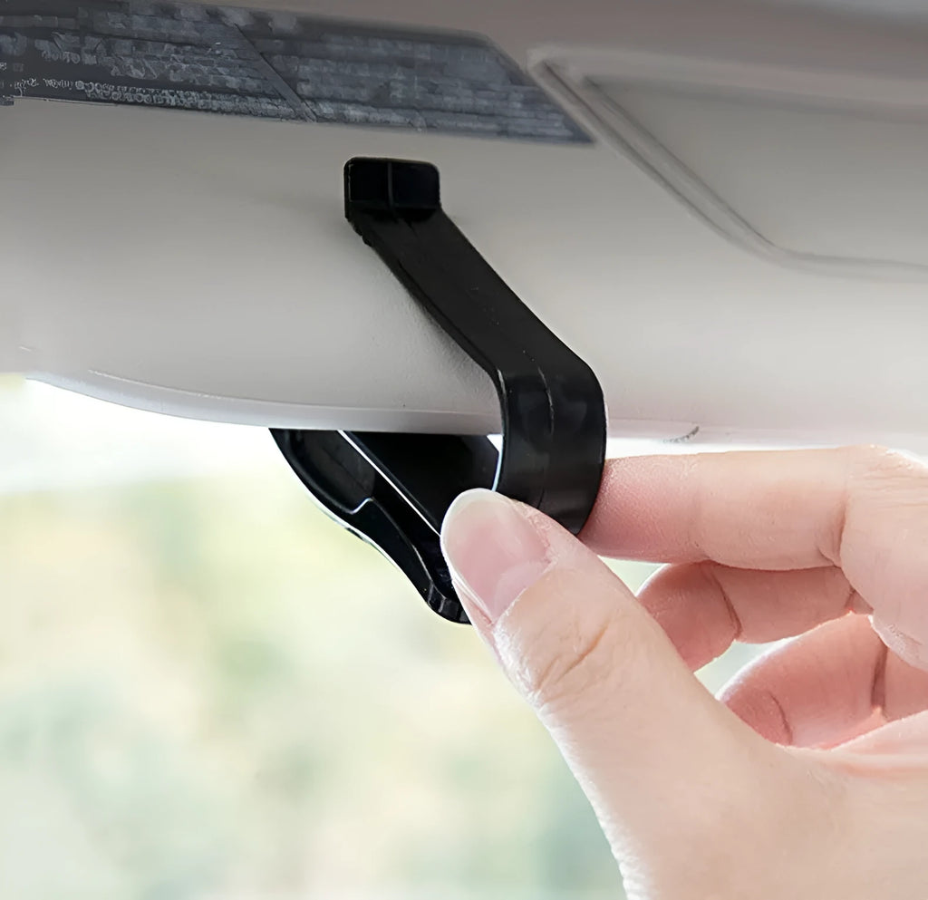 Black plastic car sunshade clip holder for glasses frames and cards measuring 6.5 by 2.3 centimetres