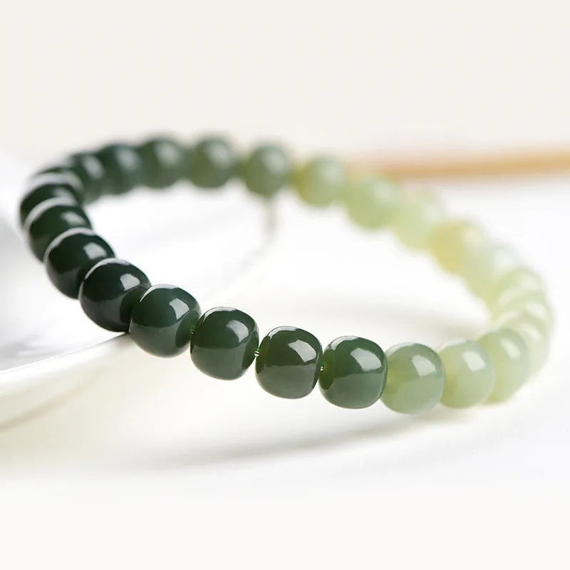 Natural Hetian jade bracelet with gradient clear water colours on wrist.
