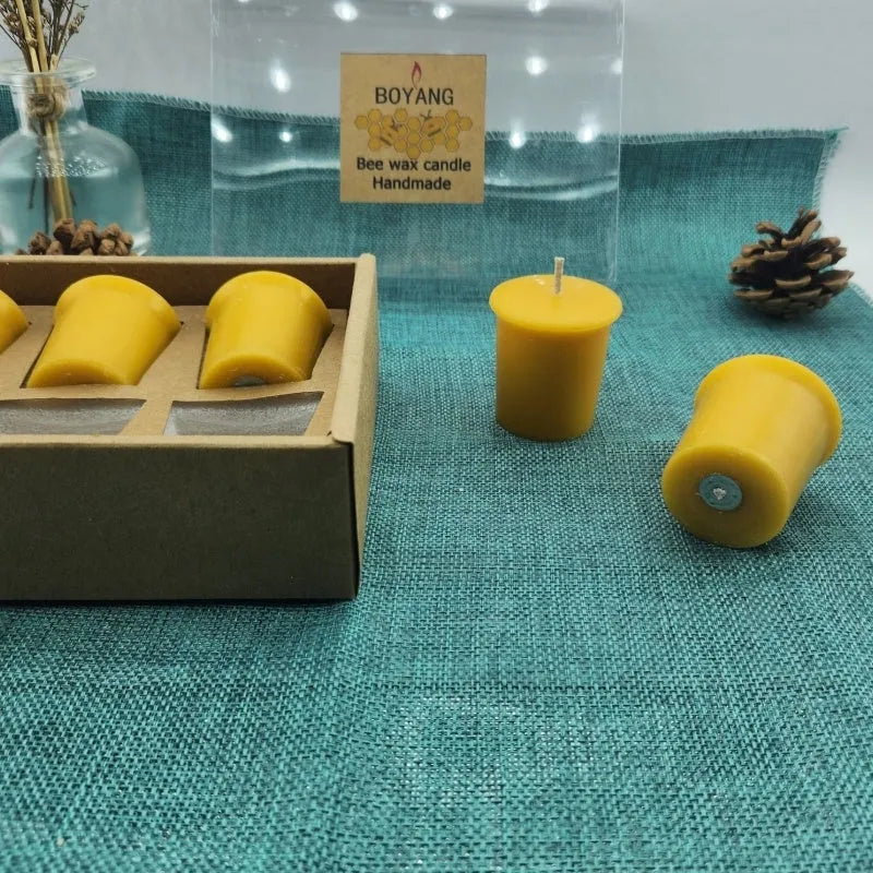 Six handmade beeswax and soy wax candles in cup shape, beeswax colour, 4.6cm x 5.2cm each, arranged on a surface
