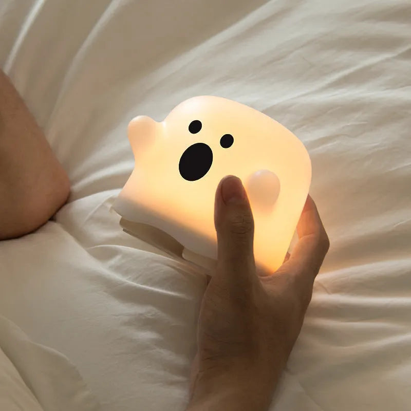 Silicone touch sensor LED night light on a bedside table showing soft glow.