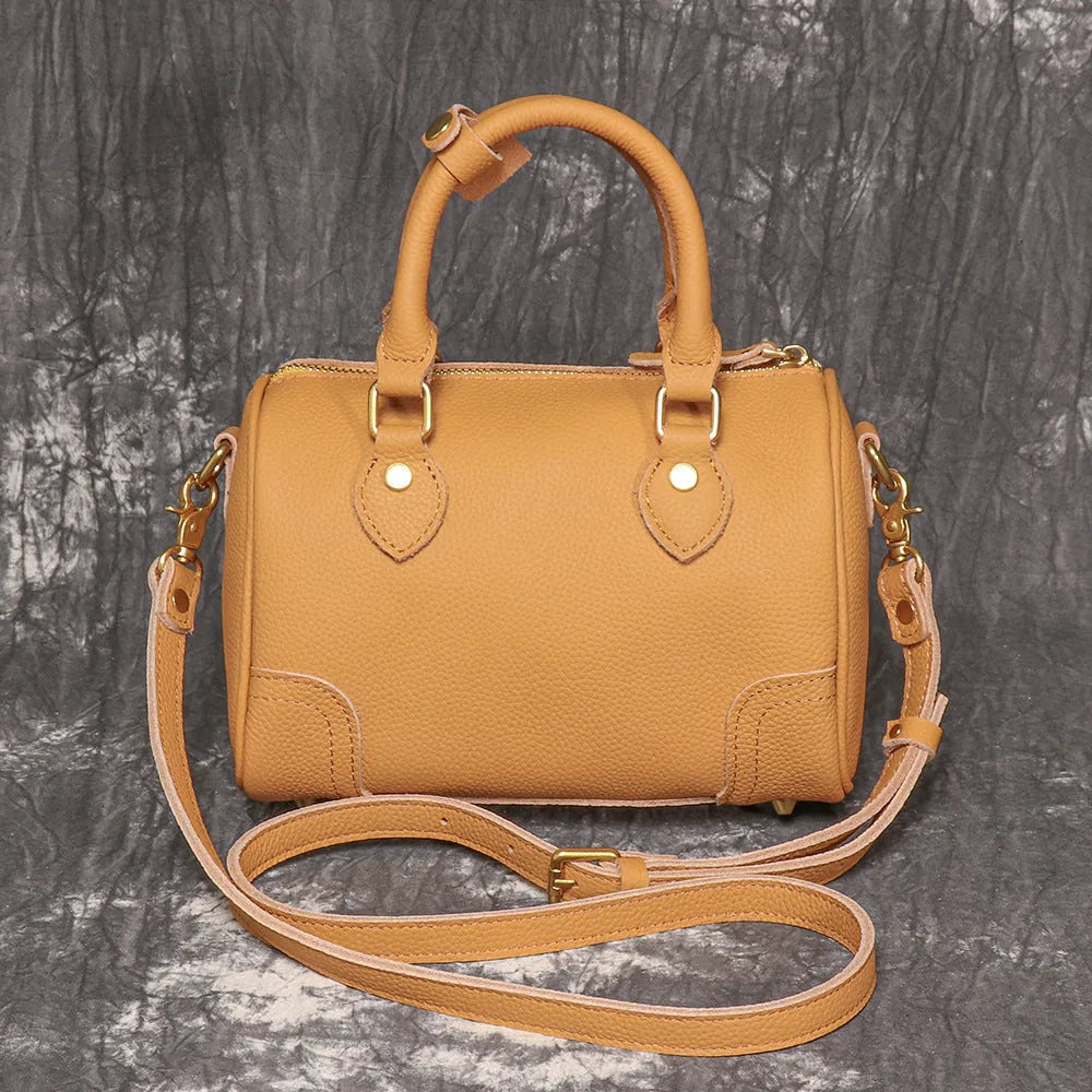 Brown yellow first layer cowhide Boston bag with cylindrical shape and single shoulder strap