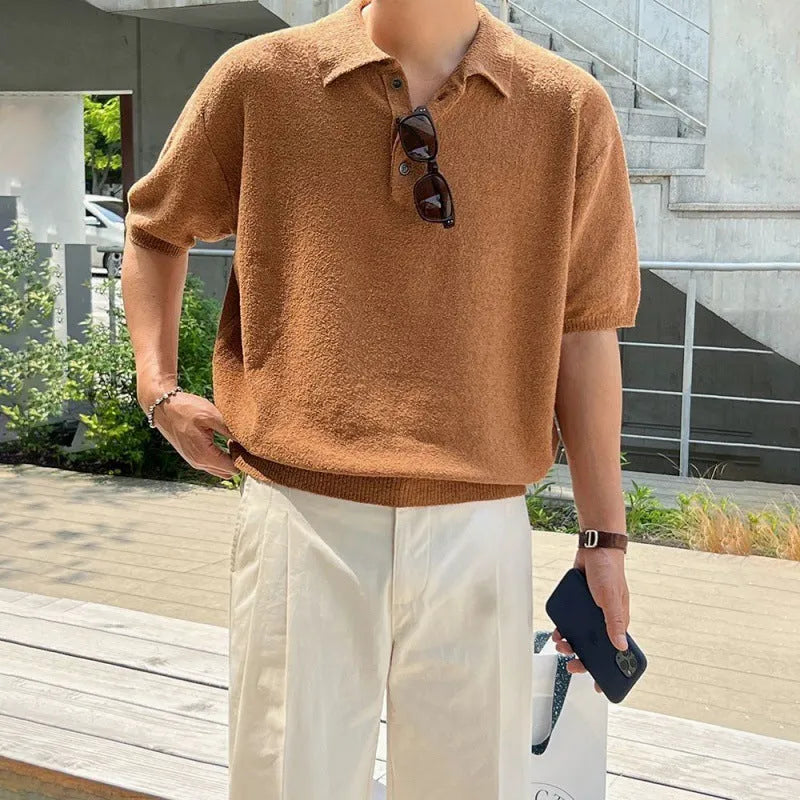 Men's caramel coloured retro knitted polo shirt with short sleeves and an asymmetrical design laid flat.