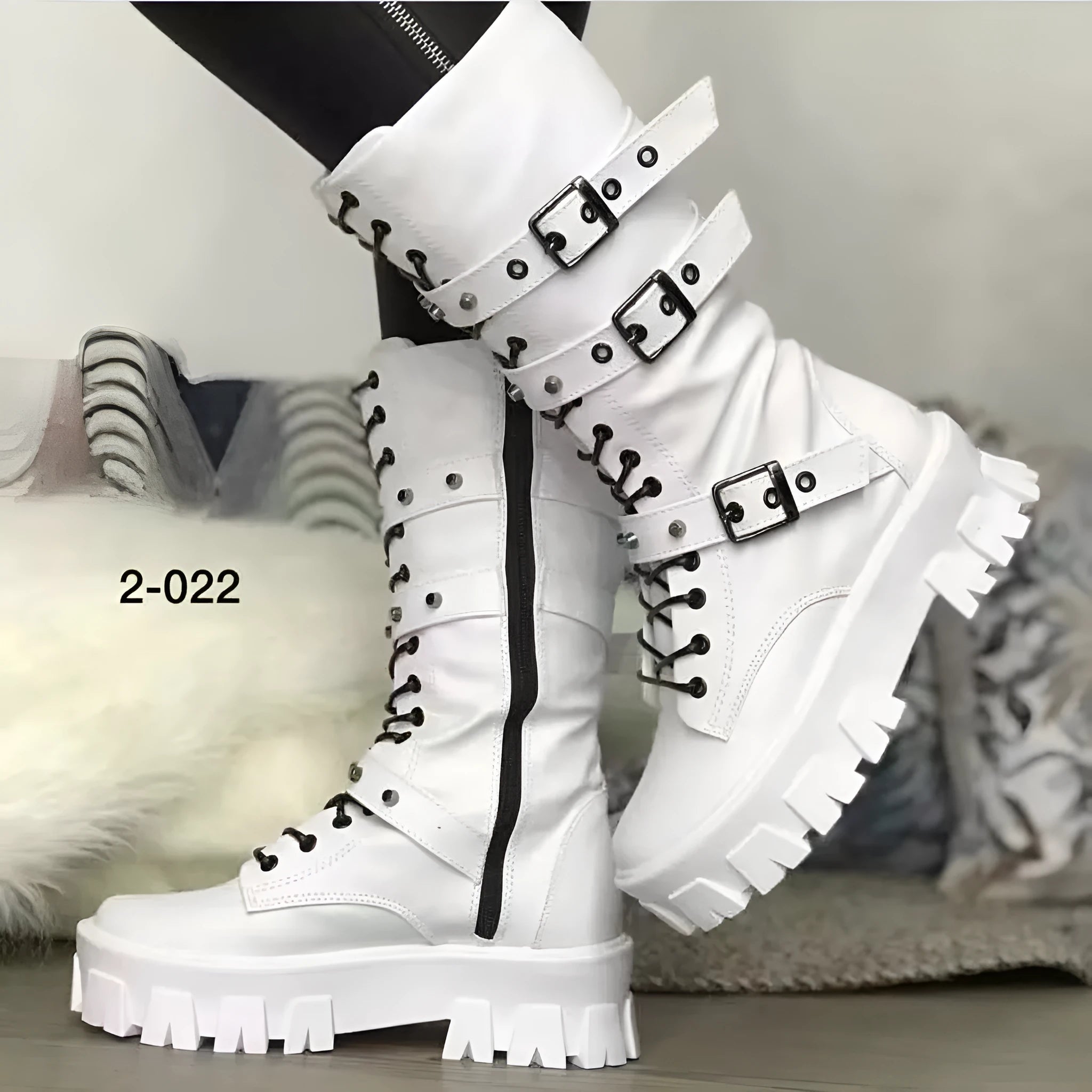 Black women's mid-calf boots with metal buckles and a side zip on a white background.
