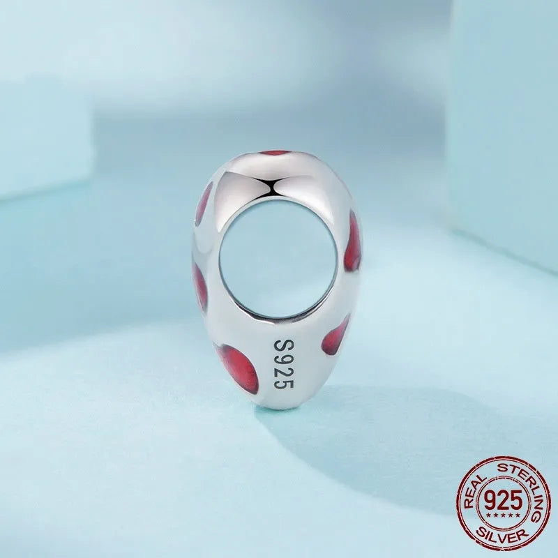 Red heart-shaped S925 sterling silver bead with glossy drip oil finish on plain background