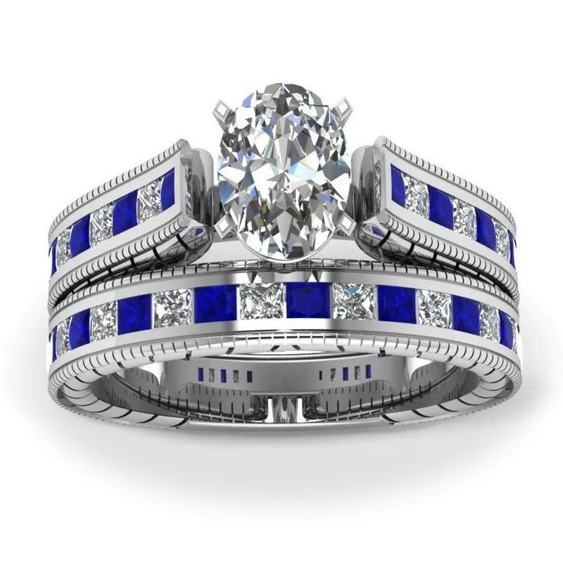 Blue alloy couple ring set with white diamond-style detail on white background
