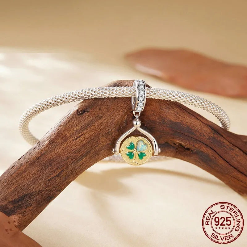 925 silver rotating card pendant with four-leaf clover pattern and wings motif on white background