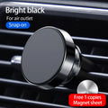 Black magnetic car phone holder attached to a car air vent, holding a smartphone at an angle.