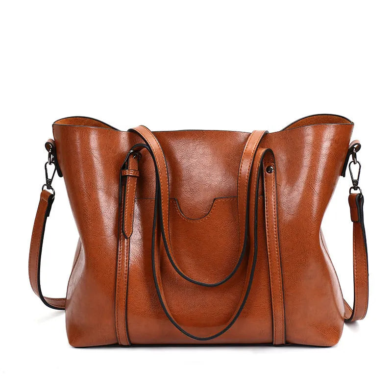 Retro-style brown PU messenger bag with flap closure and adjustable shoulder strap, shown next to an A4 magazine for scale.