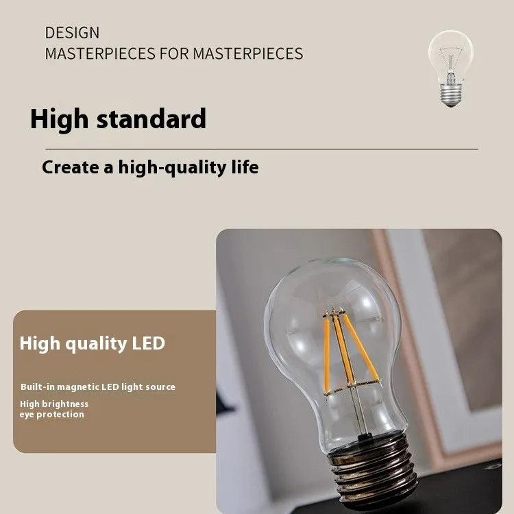 Iron art suspension bulb night lamp on a black wooden square base for desktop decoration.