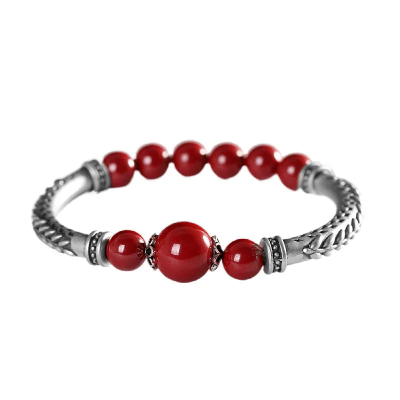 Pure silver 999 cinnabar bracelet with 10mm round retro geometric beads on neutral background