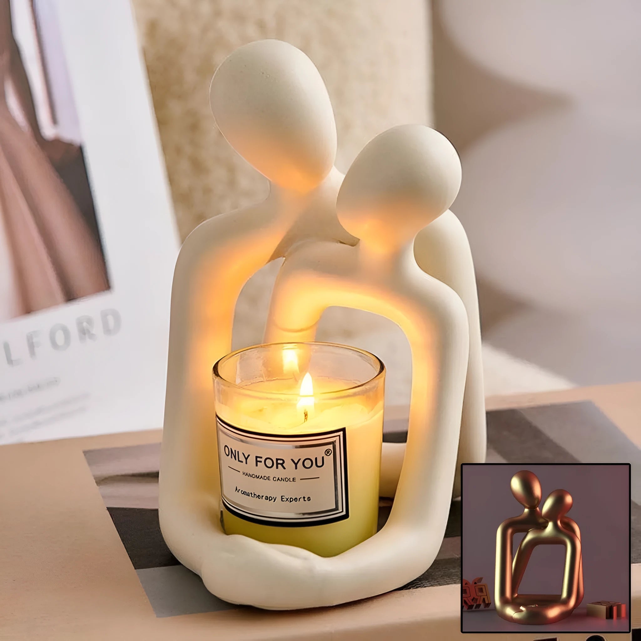 Modern loving couple resin statue in milky white or gold colour on a wooden desk.